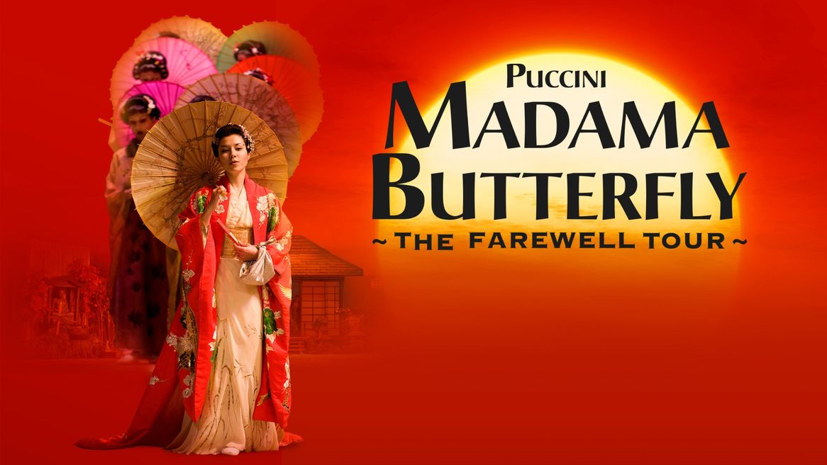 A woman in a kimono holds a parasol in front of a group of women in kimonos