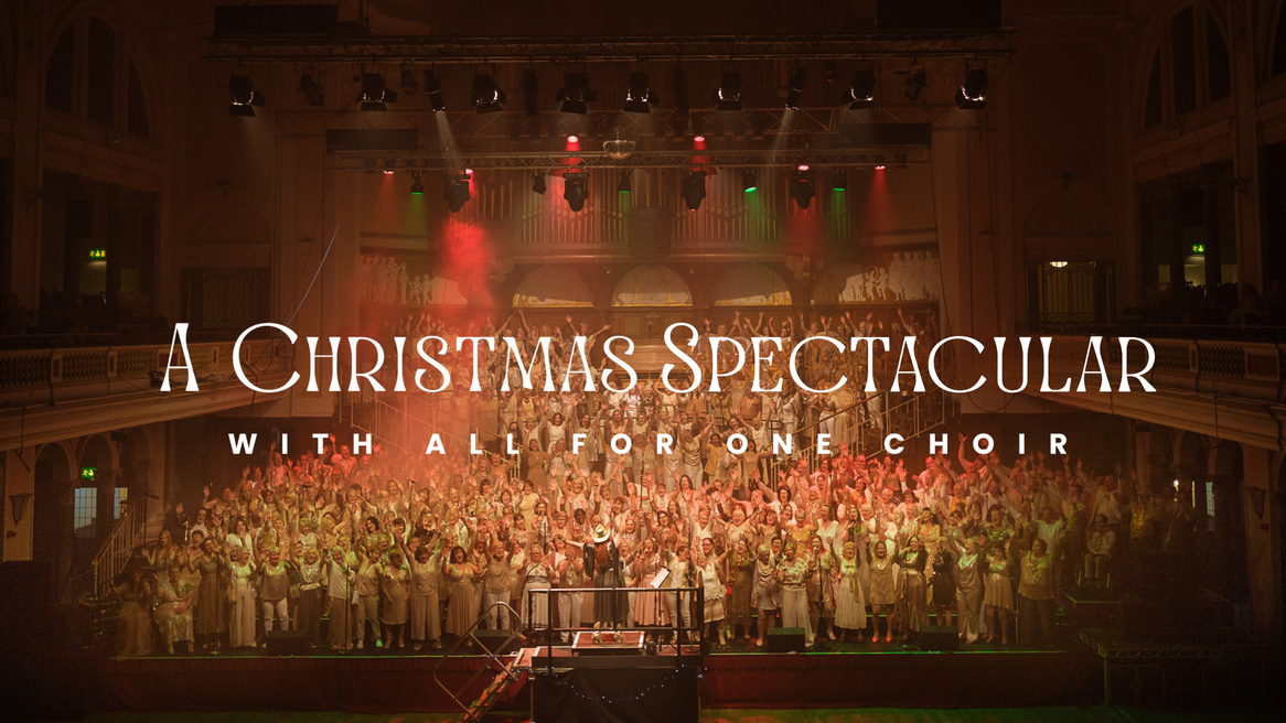 A choir in sparkly outfits sing and cheer on the Hull City Hall stage