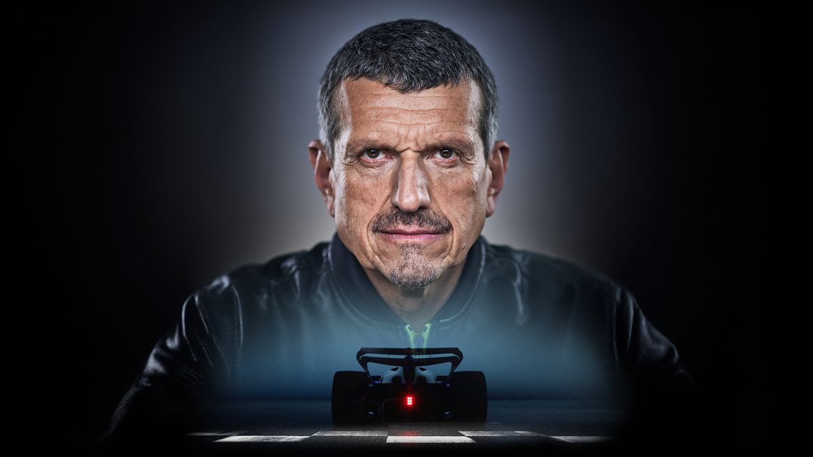 Guenther Steiner's face above over a Formula 1 Car