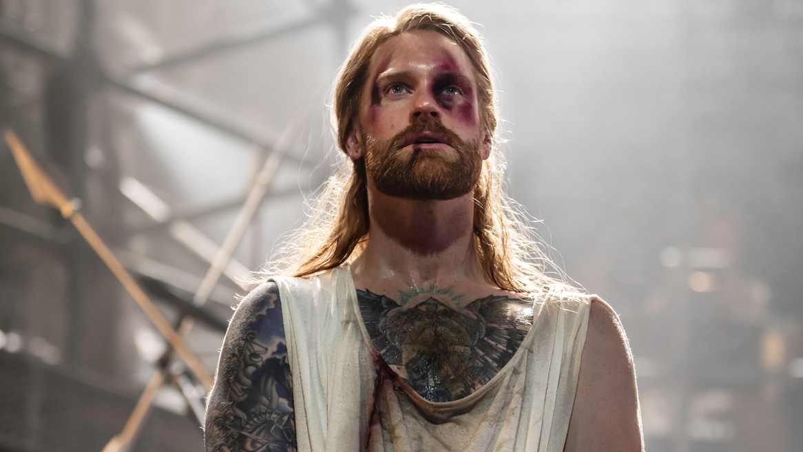 A battered and bruised Sam Ryder as Jesus stares emotionally into the distance
