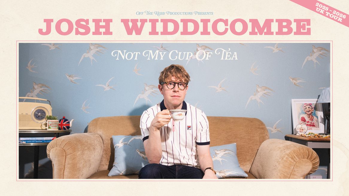 Josh Widdicombe sits in an old-fashioned living room drinking out of a floral tea cup.