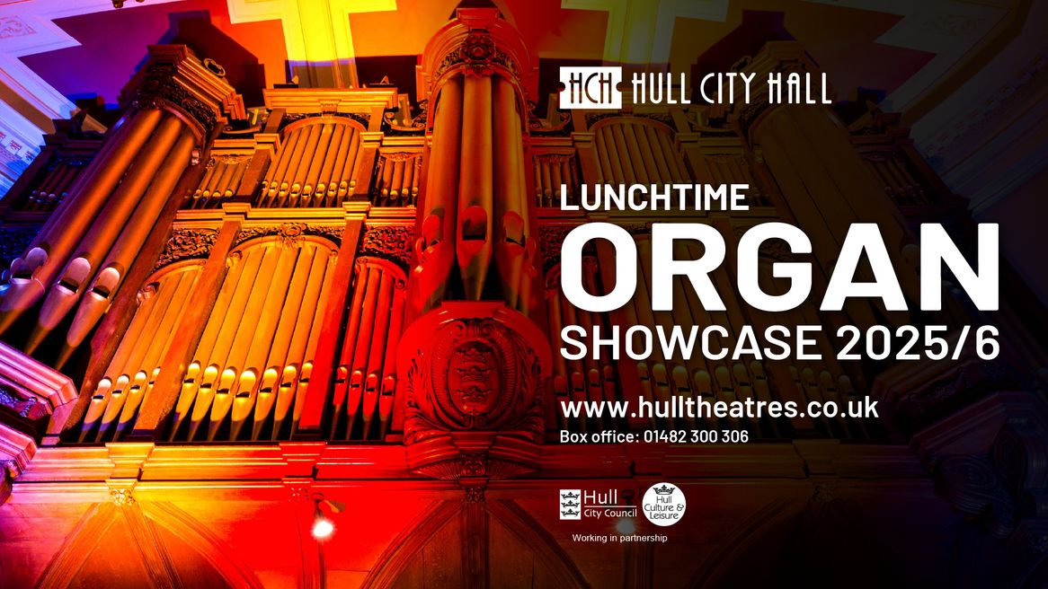 The Hull City Hall organ illuminated by a pink and yellow light