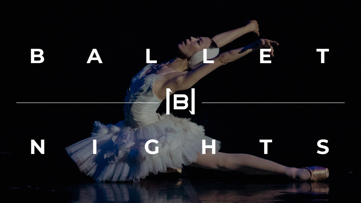 A ballet dancer in white tutu with matching headdress bows her head over her outstretched arms and leg