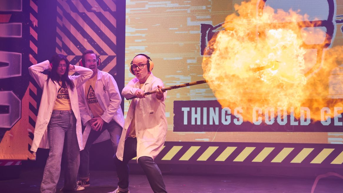 Scientists holding a flame thrower