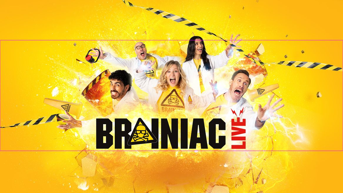 Five people laughing and screaming wearing white coats  burst out from an explosion