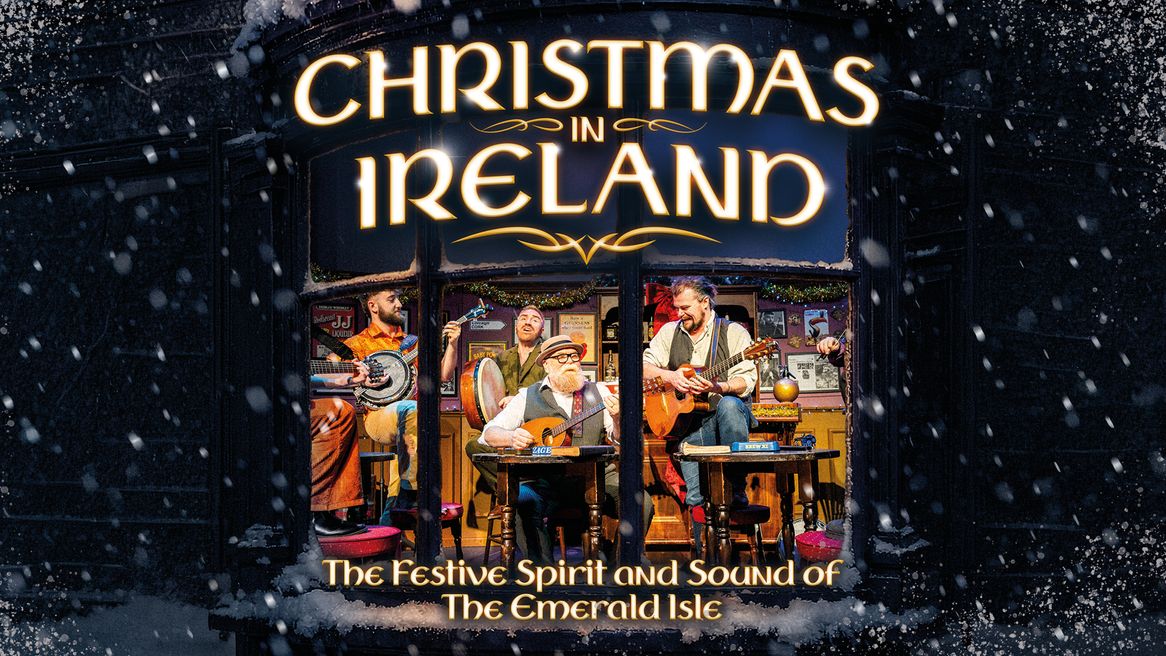 A snowy window looking into a cosy room where four men play traditional Irish instruments around a Christmas tree