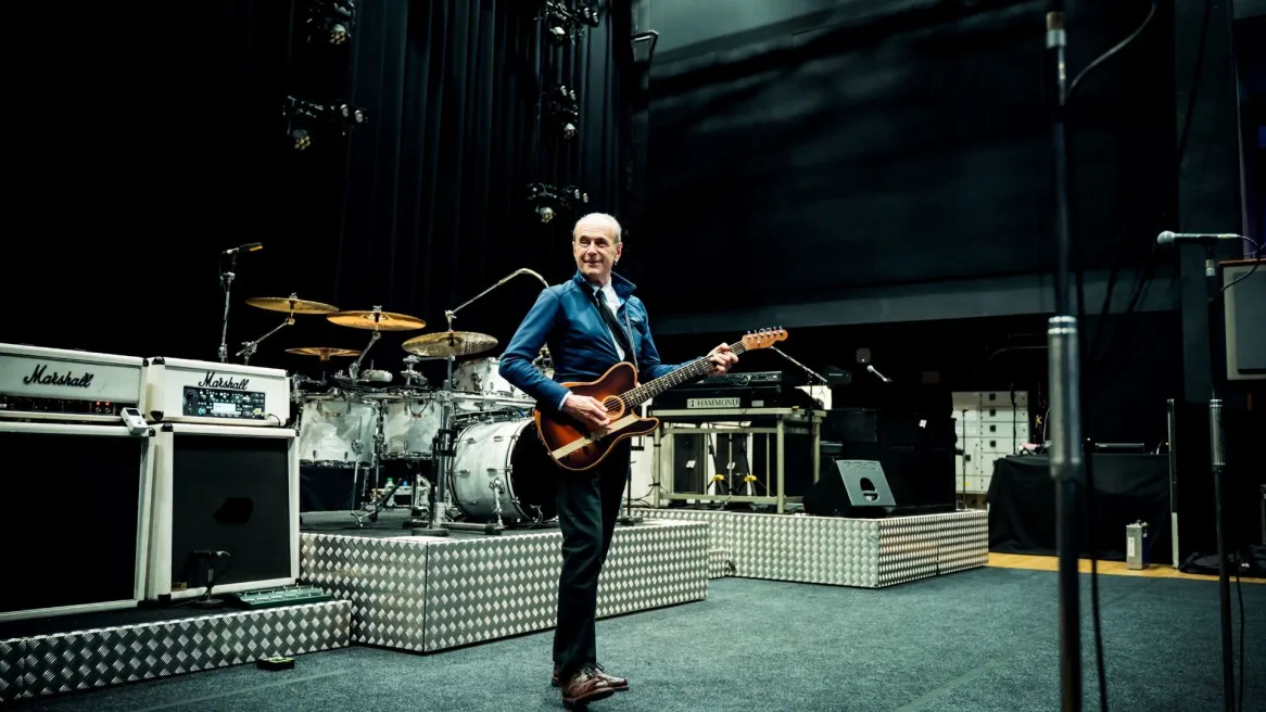 Staus Quo legend Francis Rossi on stage  playing a guitar