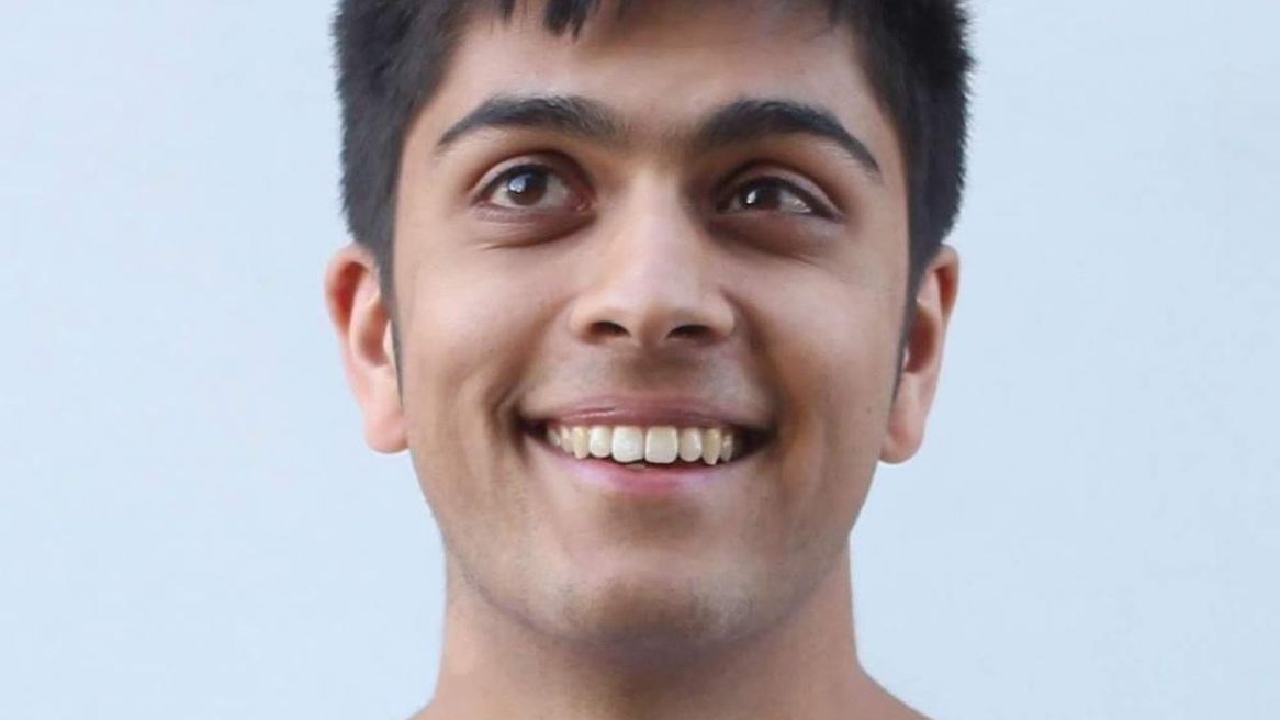 Man in a red and white stripy top smiling at the camera