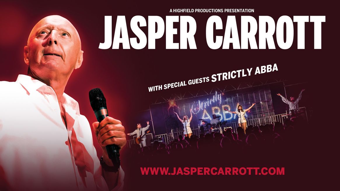 Jasper Carrott stands with a microphone in front of an ABBA tribute act