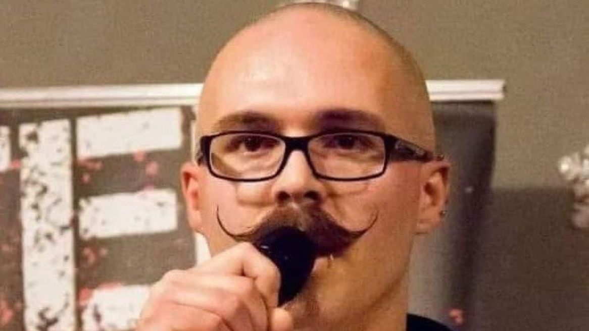 Comedian Marty Riley with a microphone 