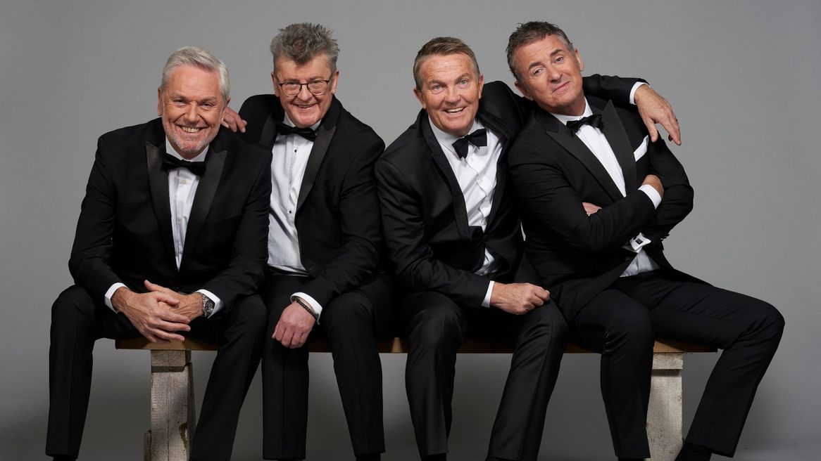 Comics Bradley Walsh, Brian Conley, Shane Richie, Joe Pasquale in tuxedos sat with their arms around each other