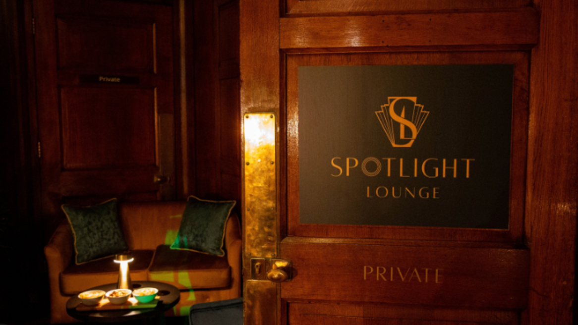 A door to the Spotlight Lounge opens to reveal a comfortable seating area