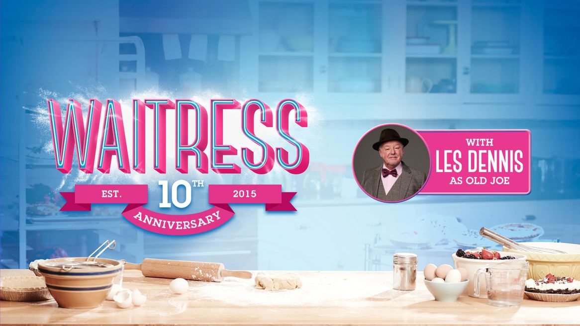 The Logo Waitress above a kitchen table with ingrediants including eggs and flour ready to bake a cake. 